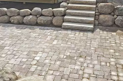 brick paver sunken surrounded by rock retaining wall