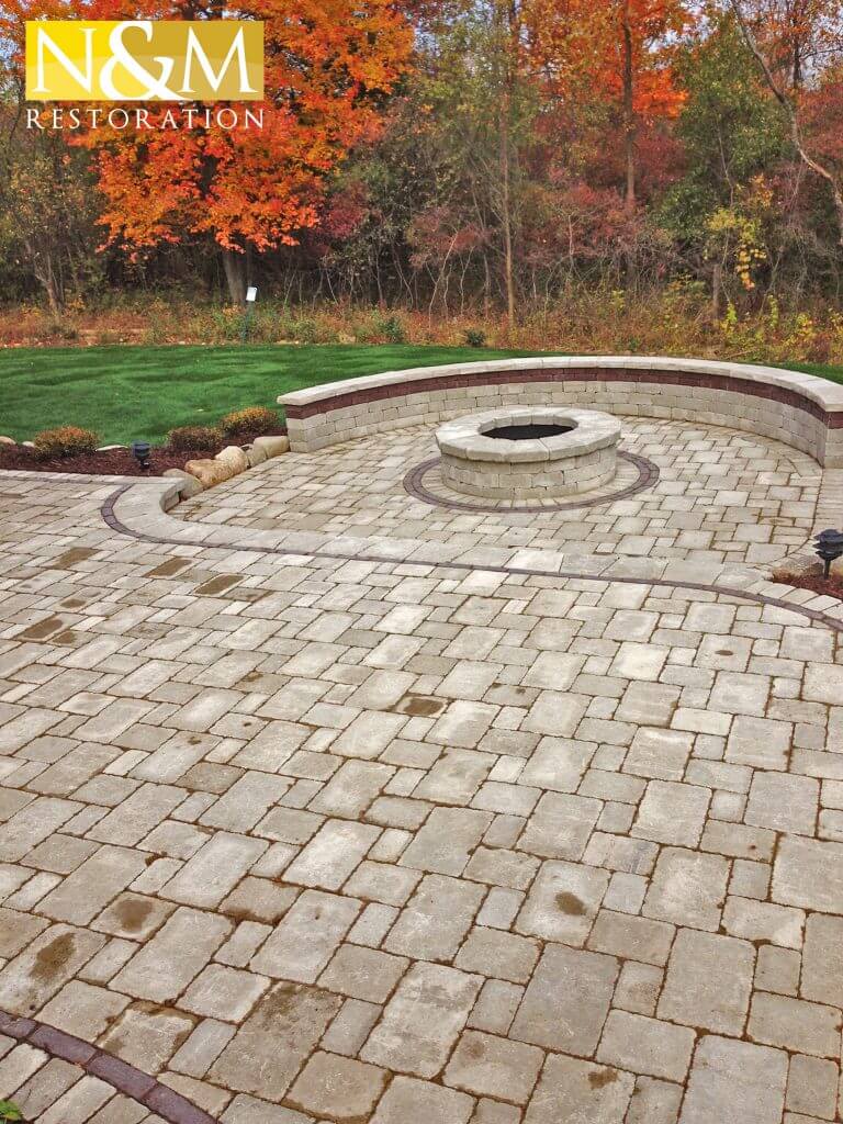 beautifully designed paver patio with firepit