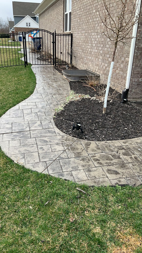 rounded stamped concrete walkway with shapes