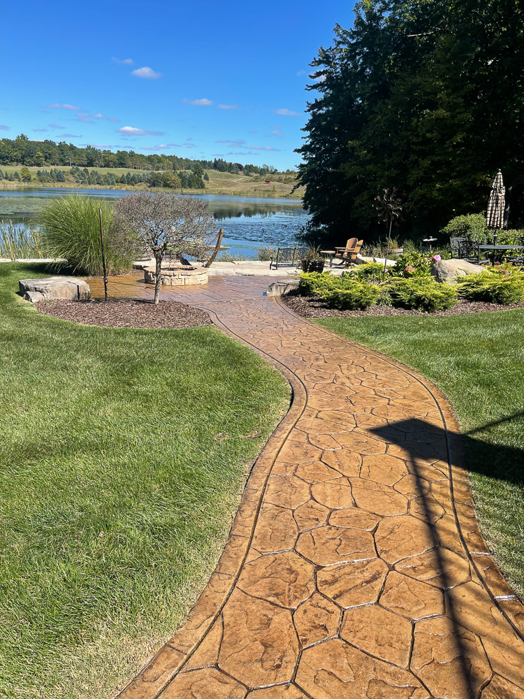 beautiful walkway leading to a hardscaping design patio