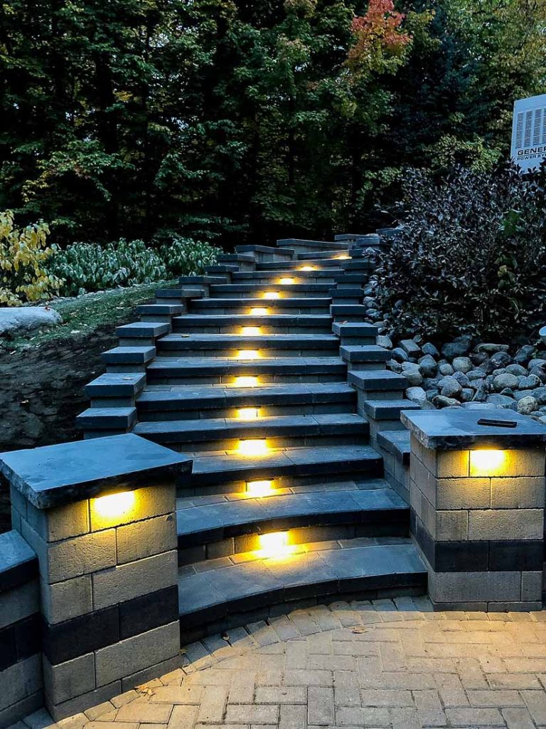 Retaining wall with integrated steps and LED lighting; illustrating the versatility of retaining walls in creating functional and accessible areas