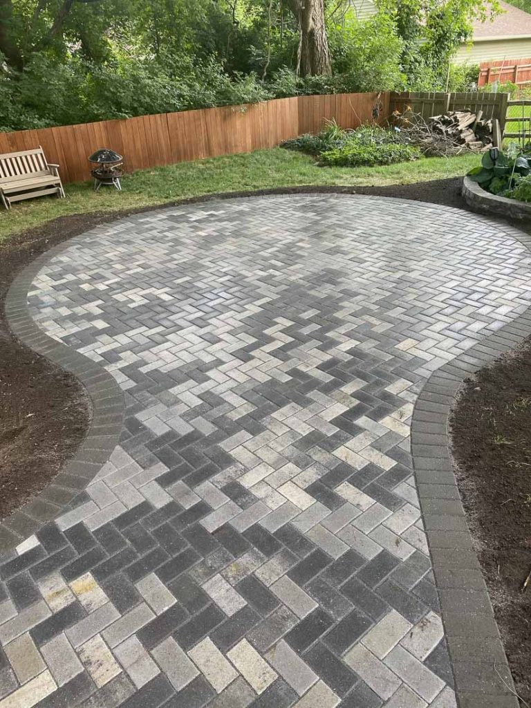 brick paver patio in herringbone and circular pattern