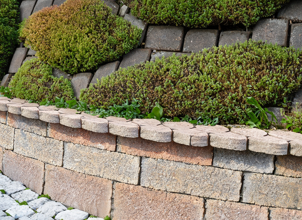 a perfectly constructed retaining wall made with brick pavers