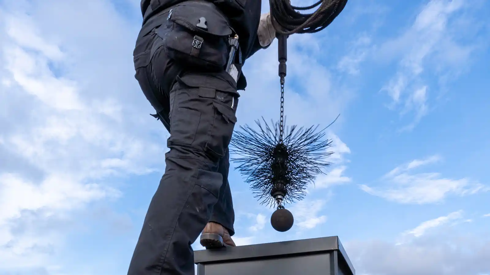 chimney cleaning maintenance man cleaning chimney sweep