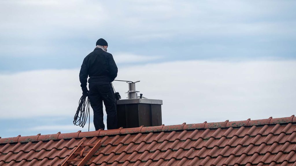 chimney inspection service man inspecting chimney