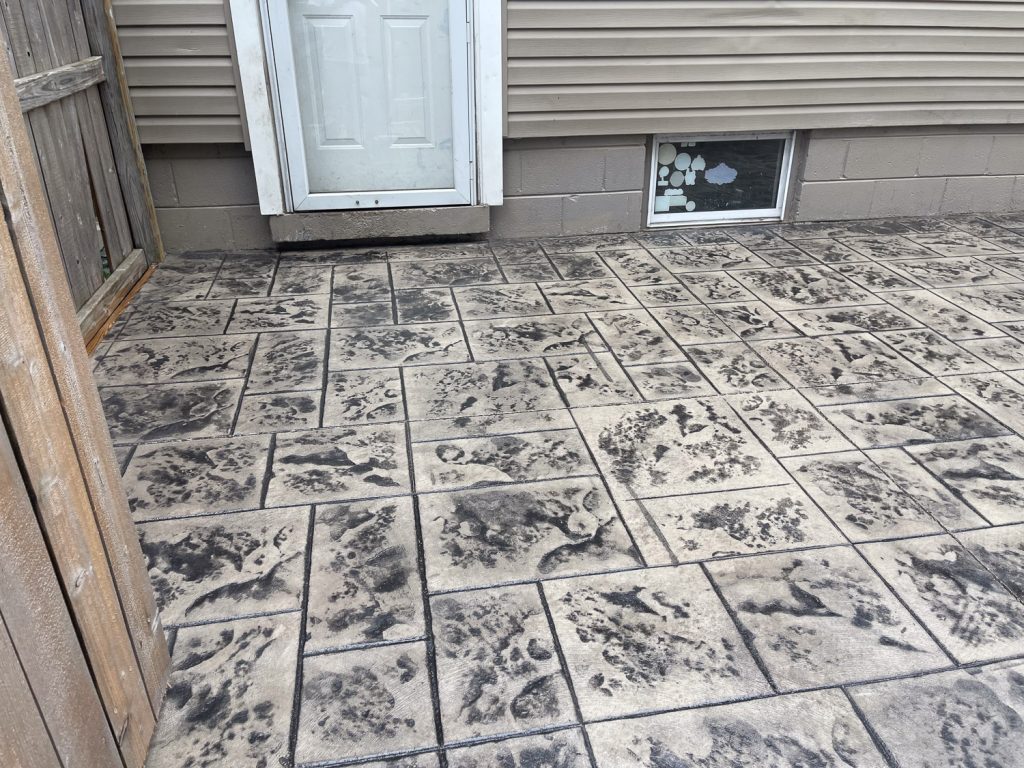 patio on back and side of house made of stamped comcrete 