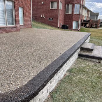 aggregate concrete patio off of house
